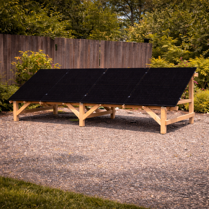 Scene - Solar panels on a wooden frame outdoors with trees in the background