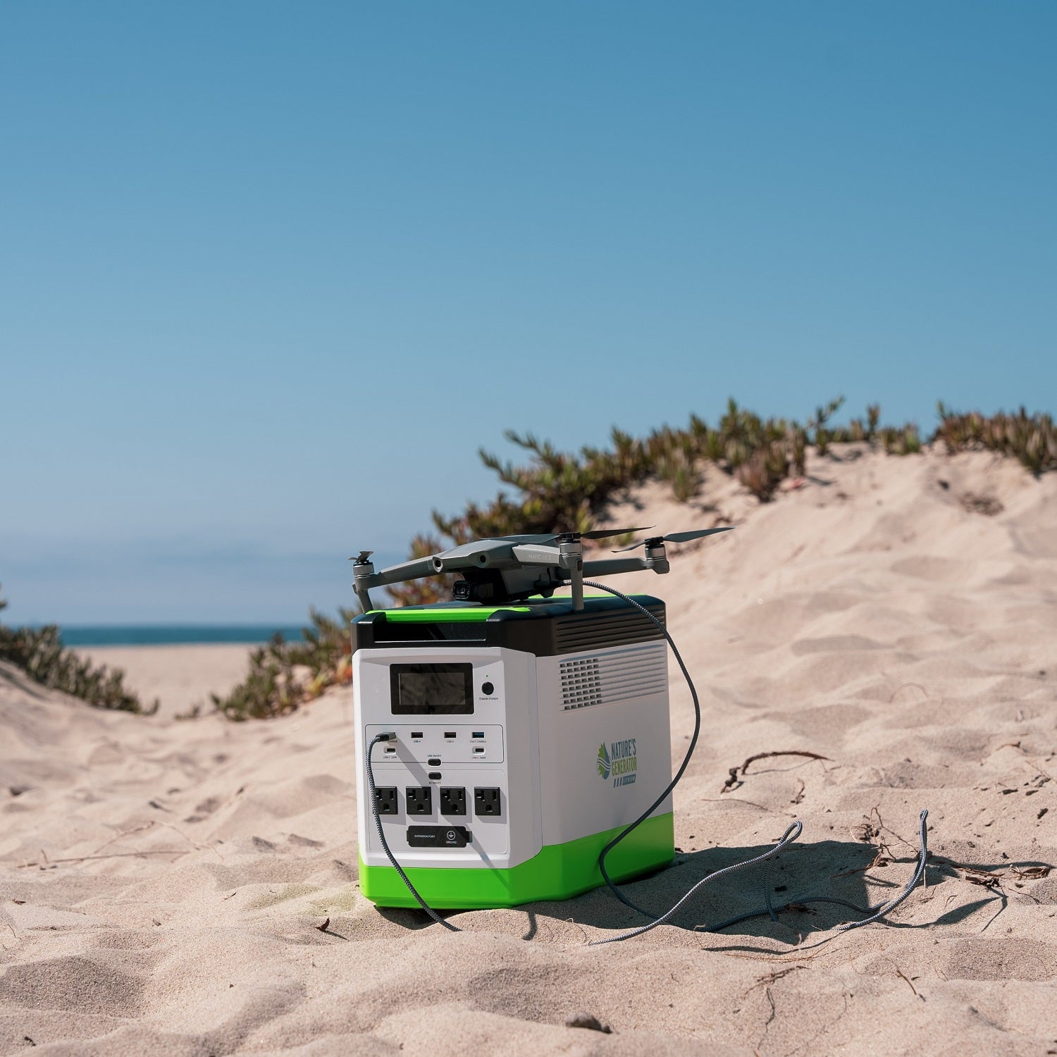 Scene Portable power station with a drone on a sandy beach