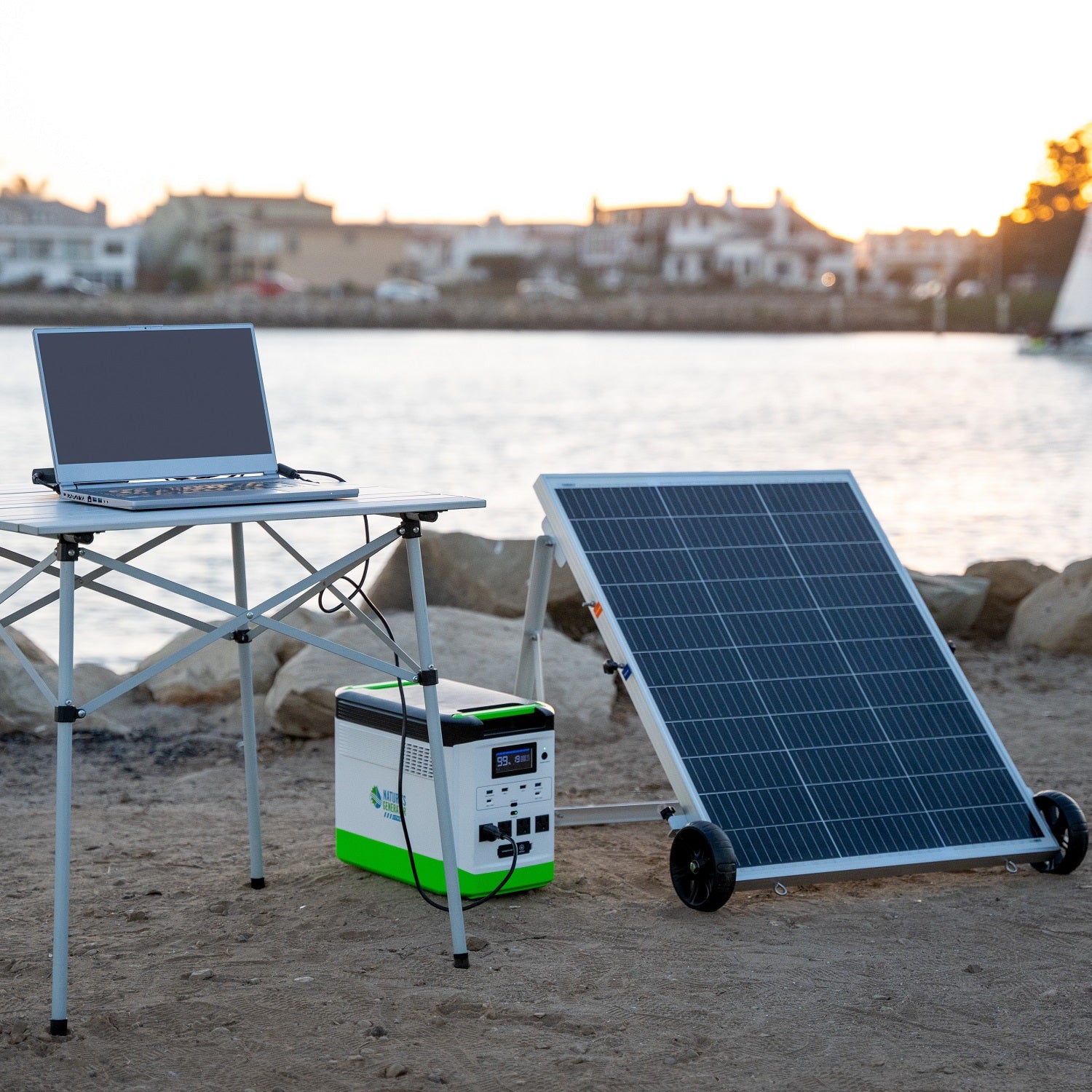 Scene Solar panel, portable power station, and laptop on a beach with a scenic background.